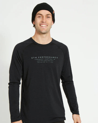 Man wearing a black long-sleeve shirt with XTM Performance logo on a white background